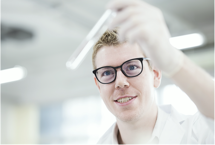 Man looking at a test tube